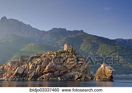 Stock Image - "The Genoese Tower of Porto on top of a rocky hill and the Gulf of Porto, Guaita, Porto, Corsica, France, Europe". Fotosearch