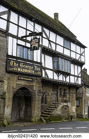 Stock Image - "The George Inn, a 700 year old heritage listed building, tourist accommodation in the village of Norton St Philip, Somerset, England, United Kingdom, Europe". Fotosearch
