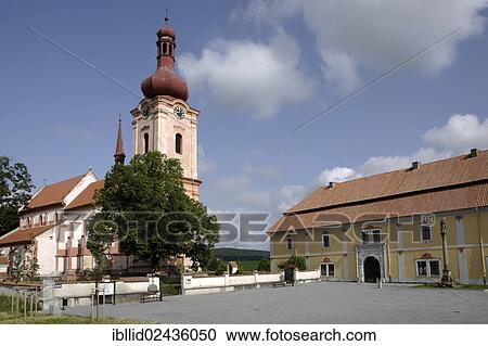 Stock Image - "The Gothic Church of St. James on Pschesanitz Square, archdeanery building on the right, Nepomuk, Bohemia, Czech Republic, Europe". Fotosearch