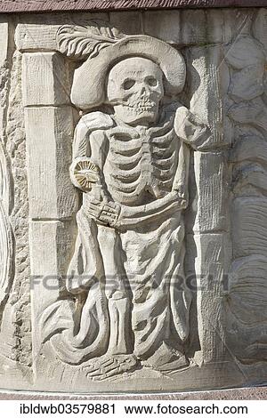 Stock Image - "The Grim Reaper, fairy tale fountain, Steinau an der Strasse, Hesse, Germany, Europe". Fotosearch