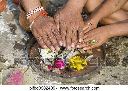 "The hands of a man and a boy are placed over human bones during Dashkriya or Asthi Visarjan, a ritual which is performed 10 days after the death of a family member, Nasik, Maharashtra, India, Asia" View Large Photo Image Stock Photo - "The hands of a man and a boy are placed over human bones during Dashkriya or Asthi Visarjan, a ritual which is performed 10 days after the death of a family member, Nasik, Maharashtra, India, Asia". Fotosearch