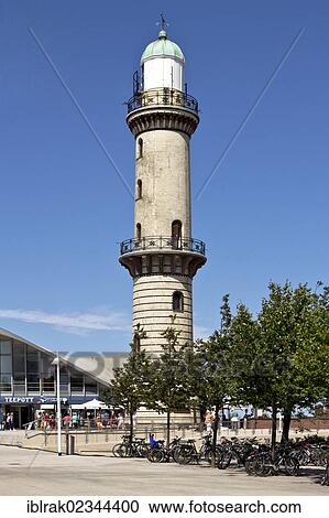 Stock Image - "The historic lighthouse and the Teepot Cafe in Rostock, Mecklenburg-Western Pomerania, Germany, Europe". Fotosearch