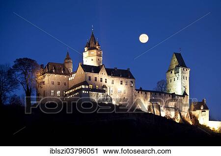 "The illuminated Burg Altena Castle, with a full moon, Altena, Sauerland region, North Rhine-Westphalia, Germany, Europe" View Large Photo Image Stock Image - "The illuminated Burg Altena Castle, with a full moon, Altena, Sauerland region, North Rhine-Westphalia, Germany, Europe". Fotosearch