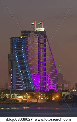 "The illuminated Jumeirah Beach Hotel on Jumeirah beach at dusk, Emirate of Dubai, United Arab Emirates, Asia" View Large Photo Image Stock Photo - "The illuminated Jumeirah Beach Hotel on Jumeirah beach at dusk, Emirate of Dubai, United Arab Emirates, Asia". Fotosearch