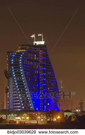 "The illuminated Jumeirah Beach Hotel on Jumeirah beach at dusk, Emirate of Dubai, United Arab Emirates, Asia" View Large Photo Image Stock Photo - "The illuminated Jumeirah Beach Hotel on Jumeirah beach at dusk, Emirate of Dubai, United Arab Emirates, Asia". Fotosearch