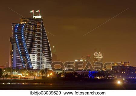 "The illuminated Jumeirah Beach Hotel on Jumeirah beach at dusk, Emirate of Dubai, United Arab Emirates, Asia" View Large Photo Image Stock Photo - "The illuminated Jumeirah Beach Hotel on Jumeirah beach at dusk, Emirate of Dubai, United Arab Emirates, Asia". Fotosearch