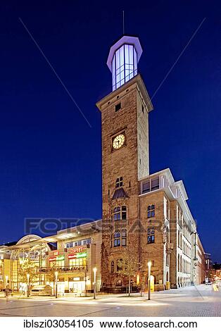 "The illuminated town hall tower with the Volme Galerie shopping centre in Friedrich-Ebert-Platz square at dusk, Hagen, North Rhine-Westphalia, Germany, Europe" View Large Photo Image Stock Photography - "The illuminated town hall tower with the Volme Galerie shopping centre in Friedrich-Ebert-Platz square at dusk, Hagen, North Rhine-Westphalia, Germany, Europe". Fotosearch
