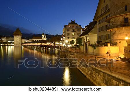 "The lights of Chapel Bridge and the water tower are reflected in the water of the Reuss river, Lucerne, Switzerland, Europe" View Large Photo Image Stock Image - "The lights of Chapel Bridge and the water tower are reflected in the water of the Reuss river, Lucerne, Switzerland, Europe". Fotosearch