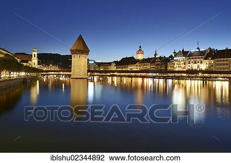 "The lights of Chapel Bridge and the water tower are reflected in the water of the Reuss river, Lucerne, Switzerland, Europe" View Large Photo Image Stock Image - "The lights of Chapel Bridge and the water tower are reflected in the water of the Reuss river, Lucerne, Switzerland, Europe". Fotosearch
