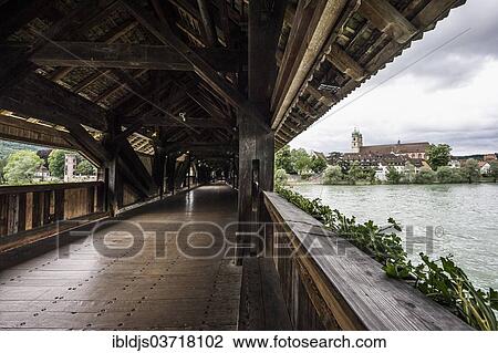 Stock Image - "The longest covered wooden bridge in Europe, Rhine River, St. Fridolin's Minster at the rear, Bad Sackingen, Baden-Wurttemberg, Germany, Europe". Fotosearch
