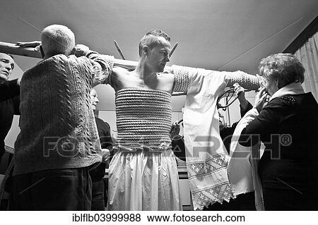"The man who takes part as an """"Empalao"""" in the procession is being prepared, with arms outstretched he is tied to a cross bar with hemp rope, Valverde de la Vera, Extremadura, Spain, Europe" View Large Photo Image Stock Photo - "The man who takes part as an """"Empalao"""" in the procession is being prepared, with arms outstretched he is tied to a cross bar with hemp rope, Valverde de la Vera, Extremadura, Spain, Europe". Fotosearch