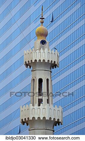 "The minaret of a small mosque against the modern glass and steel facade of a skyscraper, Abu Dhabi, United Arab Emirates, Asia" View Large Photo Image Stock Image - "The minaret of a small mosque against the modern glass and steel facade of a skyscraper, Abu Dhabi, United Arab Emirates, Asia". Fotosearch