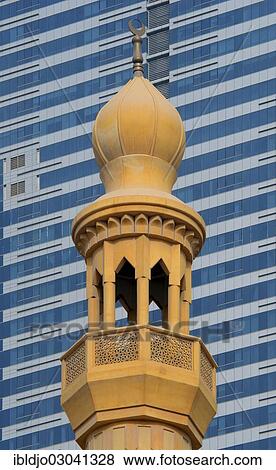 "The minaret of a small mosque against the modern glass and steel facade of a skyscraper, Abu Dhabi, United Arab Emirates, Asia" View Large Photo Image Stock Photo - "The minaret of a small mosque against the modern glass and steel facade of a skyscraper, Abu Dhabi, United Arab Emirates, Asia". Fotosearch