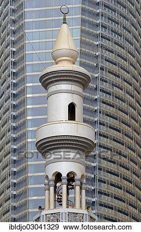 "The minaret of a small mosque against the modern glass and steel facade of a skyscraper, Abu Dhabi, United Arab Emirates, Asia" View Large Photo Image Stock Photo - "The minaret of a small mosque against the modern glass and steel facade of a skyscraper, Abu Dhabi, United Arab Emirates, Asia". Fotosearch