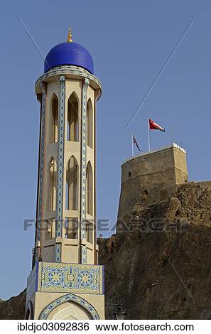 Stock Photograph - "The minaret of Al Khor Mosque or Masjid al-Khor, in front of Al Mirani Fort, Muscat, Muscat Governorate (Capital Area, Oman, Asia". Fotosearch