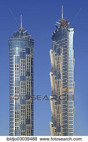 "The modern glass and steel facade of skyscrapers against a blue sky, Business Bay, Emirate of Dubai, United Arab Emirates, Asia" View Large Photo Image Stock Photo - "The modern glass and steel facade of skyscrapers against a blue sky, Business Bay, Emirate of Dubai, United Arab Emirates, Asia". Fotosearch