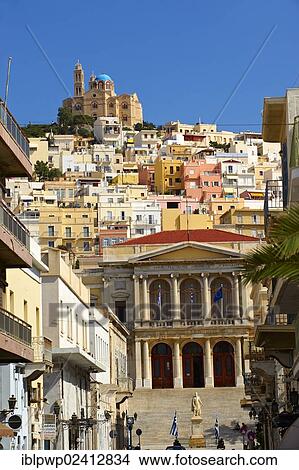 The neo-classic City Hall of Ermoupolis, Miaoulis Square and the Greek Orthodox Church of Anastasis built in 1870 on the top of Vrodado Hill, Ermoupolis, Syros, Cyclades Islands, Greece, Europe View Large Photo Image Picture - The neo-classic City Hall of Ermoupolis, Miaoulis Square and the Greek Orthodox Church of Anastasis built in 1870 on the top of Vrodado Hill, Ermoupolis, Syros, Cyclades Islands, Greece, Europe. Fotosearch