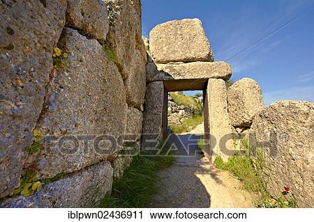 "The North Postern gate, 1250 B. C., made from four monolithic blocks of """"Almond Stone"""" in the typical form of two upright jams, a lintel over the top and threshold, Mycenae UNESCO World Heritage Archaeological Site, Peloponnese, Greece, Europe" View Large Photo Image Stock Image - "The North Postern gate, 1250 B. C., made from four monolithic blocks of """"Almond Stone"""" in the typical form of two upright jams, a lintel over the top and threshold, Mycenae UNESCO World Heritage Archaeological Site, Peloponnese, Greece, Europe". Fotosearch