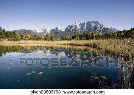 "The Northern Karwendel chain in autumn reflected in Luttensee, Karwendel Mountains, Mittenwald, Bavaria, Germany, Europe" View Large Photo Image Stock Photo - "The Northern Karwendel chain in autumn reflected in Luttensee, Karwendel Mountains, Mittenwald, Bavaria, Germany, Europe". Fotosearch