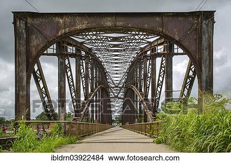 "The old arched bridge, built in 1903, now closed to road traffic, from the German colonial era, made in Oberhausen and assembled on site, Edea, Littoral Region, Cameroon, Africa" View Large Photo Image Picture - "The old arched bridge, built in 1903, now closed to road traffic, from the German colonial era, made in Oberhausen and assembled on site, Edea, Littoral Region, Cameroon, Africa". Fotosearch