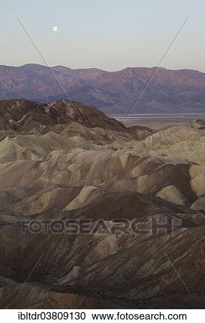 "The Panamint Range and the Death Valley at dawn, seen from Zabriskie Point, the badlands of Gower Gulch in the foreground, the Manly Beacon outcrop on the right, Death Valley National Park, California, USA" View Large Photo Image Stock Image - "The Panamint Range and the Death Valley at dawn, seen from Zabriskie Point, the badlands of Gower Gulch in the foreground, the Manly Beacon outcrop on the right, Death Valley National Park, California, USA". Fotosearch