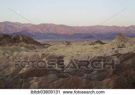 "The Panamint Range and the Death Valley at dawn, seen from Zabriskie Point, the badlands of Gower Gulch in the foreground, the Manly Beacon outcrop on the right, Death Valley National Park, California, USA" View Large Photo Image Stock Image - "The Panamint Range and the Death Valley at dawn, seen from Zabriskie Point, the badlands of Gower Gulch in the foreground, the Manly Beacon outcrop on the right, Death Valley National Park, California, USA". Fotosearch