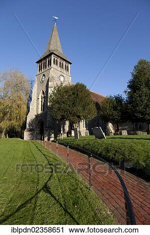 Stock Image - "The Parish Church of St Nicholas, with shingle spire, Wickham Village, Fareham, Hampshire, England, United Kingdom, Europe". Fotosearch