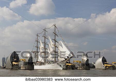 Stock Image - "The Polish sail training ship Dar Mlodziezy passes through the flood protection barrier of the River Thames, Thames Barrier, Royal Greenwich Tall Ships Festival, near Woolwich, London, England, United Kingdom, Europe". Fotosearch