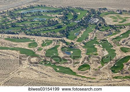 Stock Photo - "The Primm Valley Golf Club, scarce desert water is used to water the greens and to keep artificial lakes filled, Mojave Desert, Nipton, California, United States, North America". Fotosearch