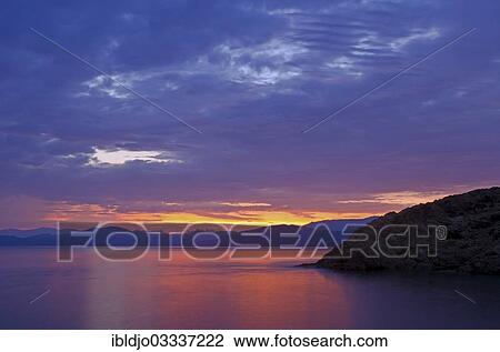 "The rising sun forms sun beams behind the rocks of the island Ile de la Pietra near L'Ile-Rousse. L'Ile-Rousse is in the department Haute-Corse, France on the mediterranean island of Corsica, Ile de la Pietra, L’Ile-Rousse, Corsica, France, Europe" View Large Photo Image Stock Image - "The rising sun forms sun beams behind the rocks of the island Ile de la Pietra near L'Ile-Rousse. L'Ile-Rousse is in the department Haute-Corse, France on the mediterranean island of Corsica, Ile de la Pietra, L’Ile-Rousse, Corsica, France, Europe". Fotosearch