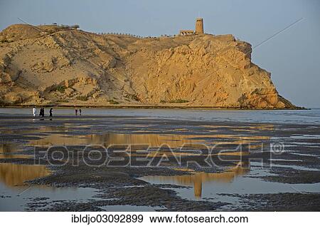 Stock Photo - "The rocky coast in Al Sawadi at the Gulf of Oman with a tower, Al Sawadi, Al Batinah, Oman, Asia". Fotosearch