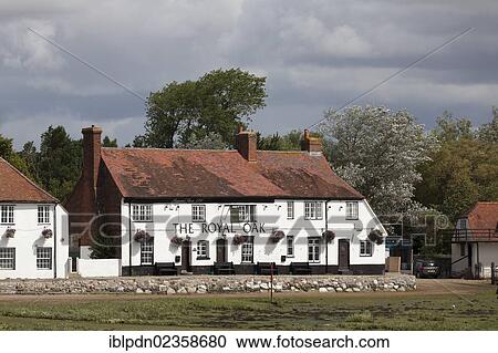 Stock Image - "The Royal Oak Pub, a waterside pub at Langston on the south coast at low tide, Havant, Hampshire, England, United Kingdom, Europe". Fotosearch