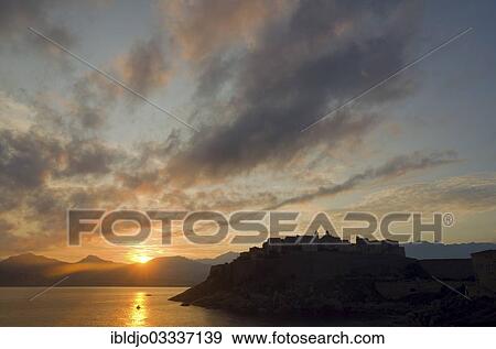 "The silhouette of the citadel (castle) of Calvi surrounded by the mediterranean sea in front of a colorful sunrise. Calvi is in the department Haute-Corse, France on the mediterranean island of Corsica, Calvi, Corsica, France, Europe" View Large Photo Image Stock Photo - "The silhouette of the citadel (castle) of Calvi surrounded by the mediterranean sea in front of a colorful sunrise. Calvi is in the department Haute-Corse, France on the mediterranean island of Corsica, Calvi, Corsica, France, Europe". Fotosearch