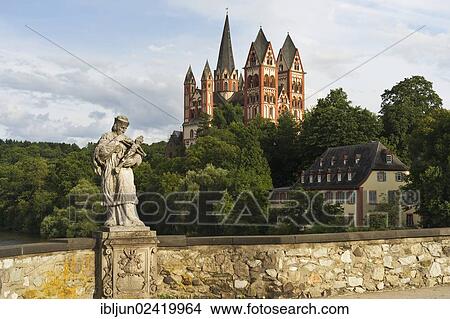 The statue of St. Nepomuk on the Alte Lahnbrucke bridge with the late Romanesque and early Gothic Limburg Cathedral of Sankt Georg, Limburg, Limburg-Weilburg, Hesse, Germany, Europe View Large Photo Image Picture - The statue of St. Nepomuk on the Alte Lahnbrucke bridge with the late Romanesque and early Gothic Limburg Cathedral of Sankt Georg, Limburg, Limburg-Weilburg, Hesse, Germany, Europe. Fotosearch
