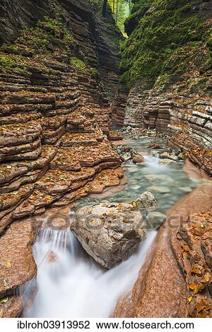 Stock Image - "The Taugl river flowing through a red gorge, Hallein District, Salzburg, Austria, Europe". Fotosearch