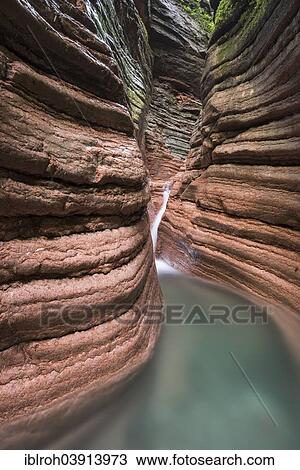 Stock Image - "The Taugl river flowing through a red gorge, Hallein District, Salzburg, Austria, Europe". Fotosearch