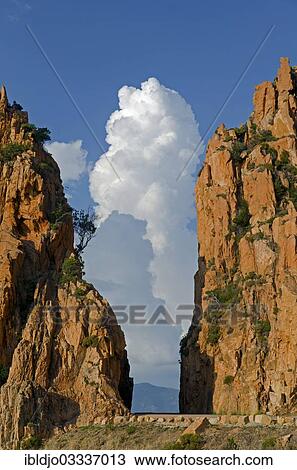 "The typical bizarre red rocks of the Calanche of Piana below a blue sky and some clouds. The Calanche of Piana is in the western part of the island Corsica, France, Calanques de Piana, Piana, Corsica, France, Europe" View Large Photo Image Stock Image - "The typical bizarre red rocks of the Calanche of Piana below a blue sky and some clouds. The Calanche of Piana is in the western part of the island Corsica, France, Calanques de Piana, Piana, Corsica, France, Europe". Fotosearch