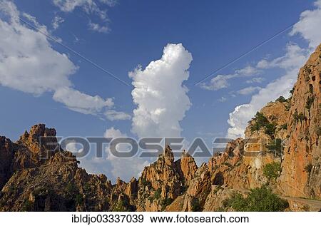 "The typical bizarre red rocks of the Calanche of Piana below a blue sky and some clouds. The Calanche of Piana is in the western part of the island Corsica, France, Calanques de Piana, Piana, Corsica, France, Europe" View Large Photo Image Stock Photo - "The typical bizarre red rocks of the Calanche of Piana below a blue sky and some clouds. The Calanche of Piana is in the western part of the island Corsica, France, Calanques de Piana, Piana, Corsica, France, Europe". Fotosearch