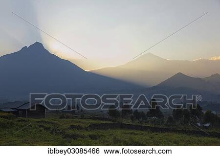 Stock Photograph - "The Virunga volcanoes Mount Mikeno and Mount Karisimbi at sunrise, Goma, Nord-Kivu, Congo, Democratic Republic of the Congo, Africa". Fotosearch