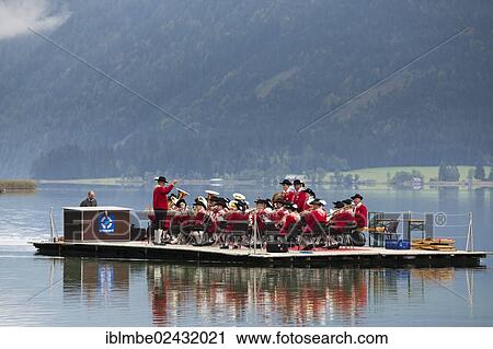 "The Weissensee marching band in traditional costumes performing on a raft at the Naturparkfest festival in Techendorf, Carinthia, Austria, Europe" View Large Photo Image Stock Image - "The Weissensee marching band in traditional costumes performing on a raft at the Naturparkfest festival in Techendorf, Carinthia, Austria, Europe". Fotosearch