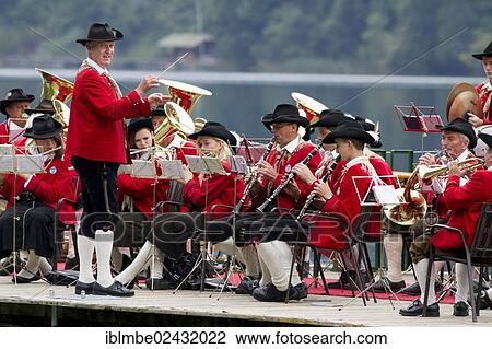 "The Weissensee marching band in traditional costumes with conductor Johann Knaller performing on a raft at the Naturparkfest festival in Techendorf, Carinthia, Austria, Europe" View Large Photo Image Stock Image - "The Weissensee marching band in traditional costumes with conductor Johann Knaller performing on a raft at the Naturparkfest festival in Techendorf, Carinthia, Austria, Europe". Fotosearch