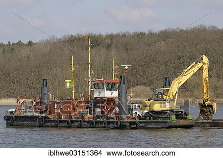 "The working vessel """"Aegir"""" carrying a mobile backhoe, to deepen the Elbe River for commercial shipping, Artlenburg, Lower Saxony, Germany, Europe" View Large Photo Image Picture - "The working vessel """"Aegir"""" carrying a mobile backhoe, to deepen the Elbe River for commercial shipping, Artlenburg, Lower Saxony, Germany, Europe". Fotosearch