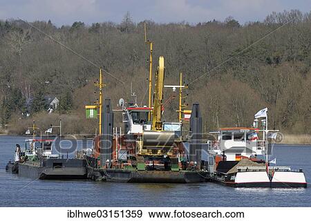 "The working vessel """"Aegir"""" carrying a mobile backhoe, to deepen the Elbe River for commercial shipping, Artlenburg, Lower Saxony, Germany, Europe" View Large Photo Image Stock Photo - "The working vessel """"Aegir"""" carrying a mobile backhoe, to deepen the Elbe River for commercial shipping, Artlenburg, Lower Saxony, Germany, Europe". Fotosearch