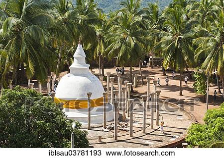 "Theravada Buddhism, white stupa with an orange band, Dagoba surrounded with stone columns under palm trees, Ambastala Vatadage, Buddhist monastery complex of Mihintale, Anuradhapura, Sri Lanka, Asia" View Large Photo Image Stock Image - "Theravada Buddhism, white stupa with an orange band, Dagoba surrounded with stone columns under palm trees, Ambastala Vatadage, Buddhist monastery complex of Mihintale, Anuradhapura, Sri Lanka, Asia". Fotosearch