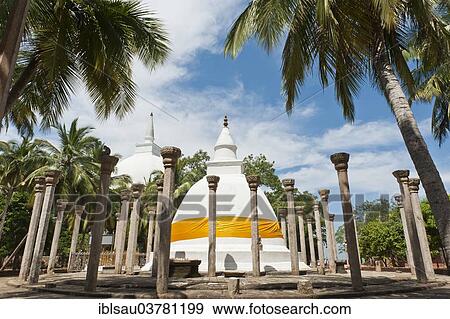 "Theravada Buddhism, white stupas, Dagoba surrounded with stone columns, Ambastala Vatadage in the middle, large white Maha Seya Dagoba behind on the left, Buddhist monastery complex of Mihintale, Anuradhapura, Sri Lanka, Asia" View Large Photo Image Stock Photo - "Theravada Buddhism, white stupas, Dagoba surrounded with stone columns, Ambastala Vatadage in the middle, large white Maha Seya Dagoba behind on the left, Buddhist monastery complex of Mihintale, Anuradhapura, Sri Lanka, Asia". Fotosearch