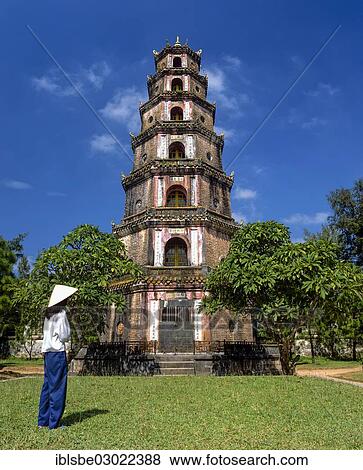 "Thien Mu Pagoda, Heavenly Lady Pagoda, woman standing in front of the seven-storey Phuoc Duyen Tower, Hue, Provinz Thua Thien-Hue, Vietnam, Asia" View Large Photo Image Stock Photo - "Thien Mu Pagoda, Heavenly Lady Pagoda, woman standing in front of the seven-storey Phuoc Duyen Tower, Hue, Provinz Thua Thien-Hue, Vietnam, Asia". Fotosearch