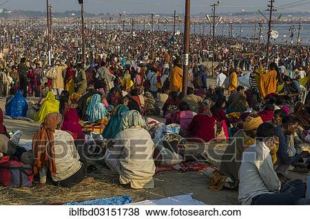 Stock Photo - "Thousands of people gathering, sitting and sleeping on the ground, Kumbha Mela mass Hindu pilgrimage, Allahabad, Uttar Pradesh, India, Asia". Fotosearch