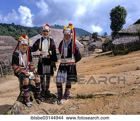 "Three Akha girls in a mountain village, in traditional costume and headdress, bamboo huts with thatched roofs at back, Chiang Rai Province, Northern Thailand, Thailand, Asia" View Large Photo Image Picture - "Three Akha girls in a mountain village, in traditional costume and headdress, bamboo huts with thatched roofs at back, Chiang Rai Province, Northern Thailand, Thailand, Asia". Fotosearch