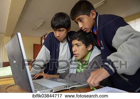 "Three boys in a children's home are working together on a laptop, Ayacucho, Ayacucho region, Peru, South America" View Large Photo Image Stock Photo - "Three boys in a children's home are working together on a laptop, Ayacucho, Ayacucho region, Peru, South America". Fotosearch
