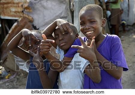 "Three boys posing with wild gestures, Camp Icare for earthquake refugees, Fort National, Port-au-Prince, Haiti, North America" View Large Photo Image Stock Image - "Three boys posing with wild gestures, Camp Icare for earthquake refugees, Fort National, Port-au-Prince, Haiti, North America". Fotosearch
